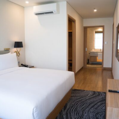 small-hotel-room-interior-with-double-bed-and-bathroom